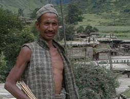 Portrait of Kamal Budha standing in Humla village, Nepal.